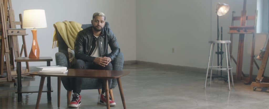 photography of man sitting in open room